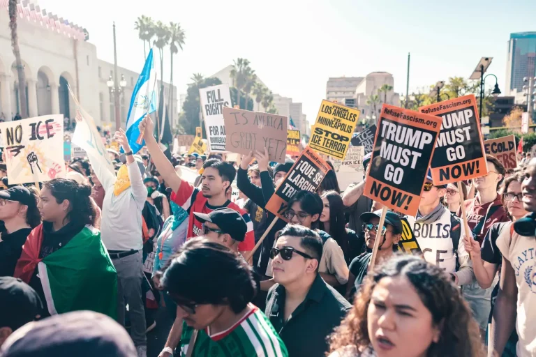 Demonstrators packed shoulder to shoulder at an immigration-enforcement protest in Los Angeles, holding hand-lettered and printed signs reading ‘No ICE’, ‘Full rights for all immigrants’ and ‘Trump must go now’.